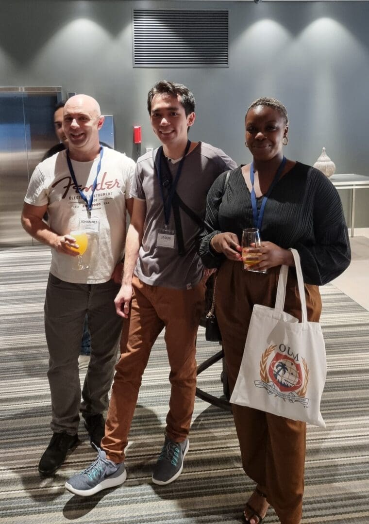 White man Asian man black woman happy casual dress med student conference OUM bag