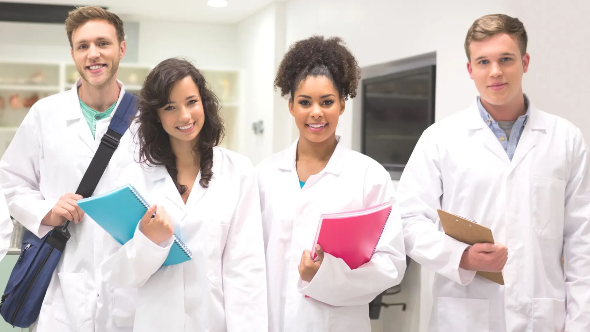 Young students in white robes in the hospital setting