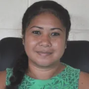 Square portrait of a smiling woman with light brown skin and dark hair. She's wearing a green shirt and looking directly at the camera.