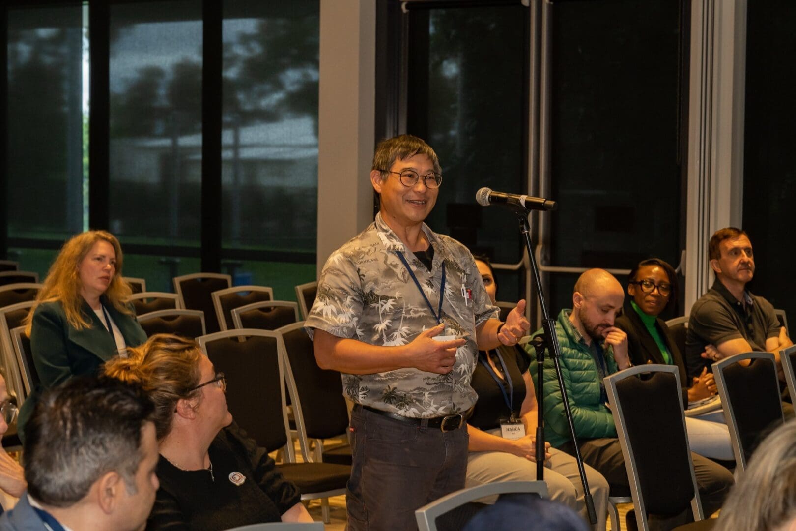 Medical student conference audience watching man asking question at microphone OUM