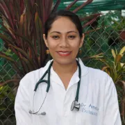 A smiling female doctor wearing a stethoscope and a lab coat.