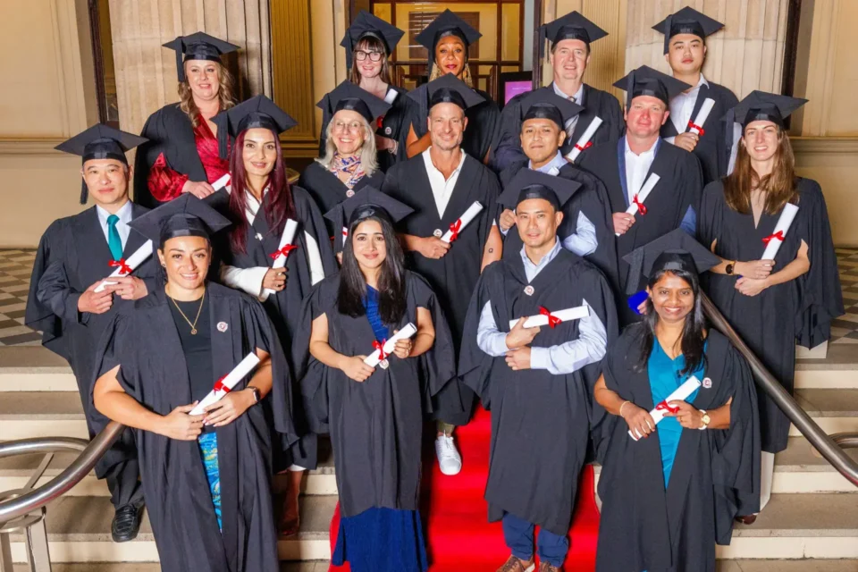 Group of graduating medical doctors in black cap and gown
