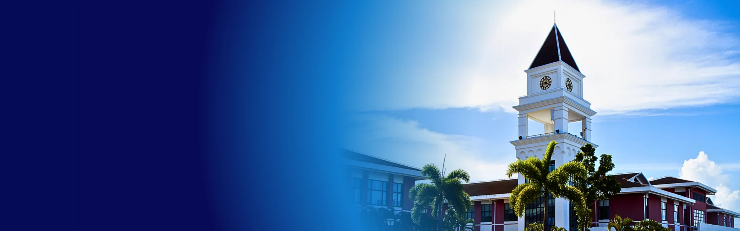 red brick and white hospital building with a clock tower with floor to ceiling windows