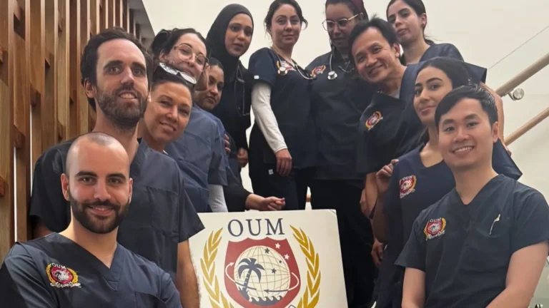 OUM CTU Students lined up on stairs surrounding the OUM banner