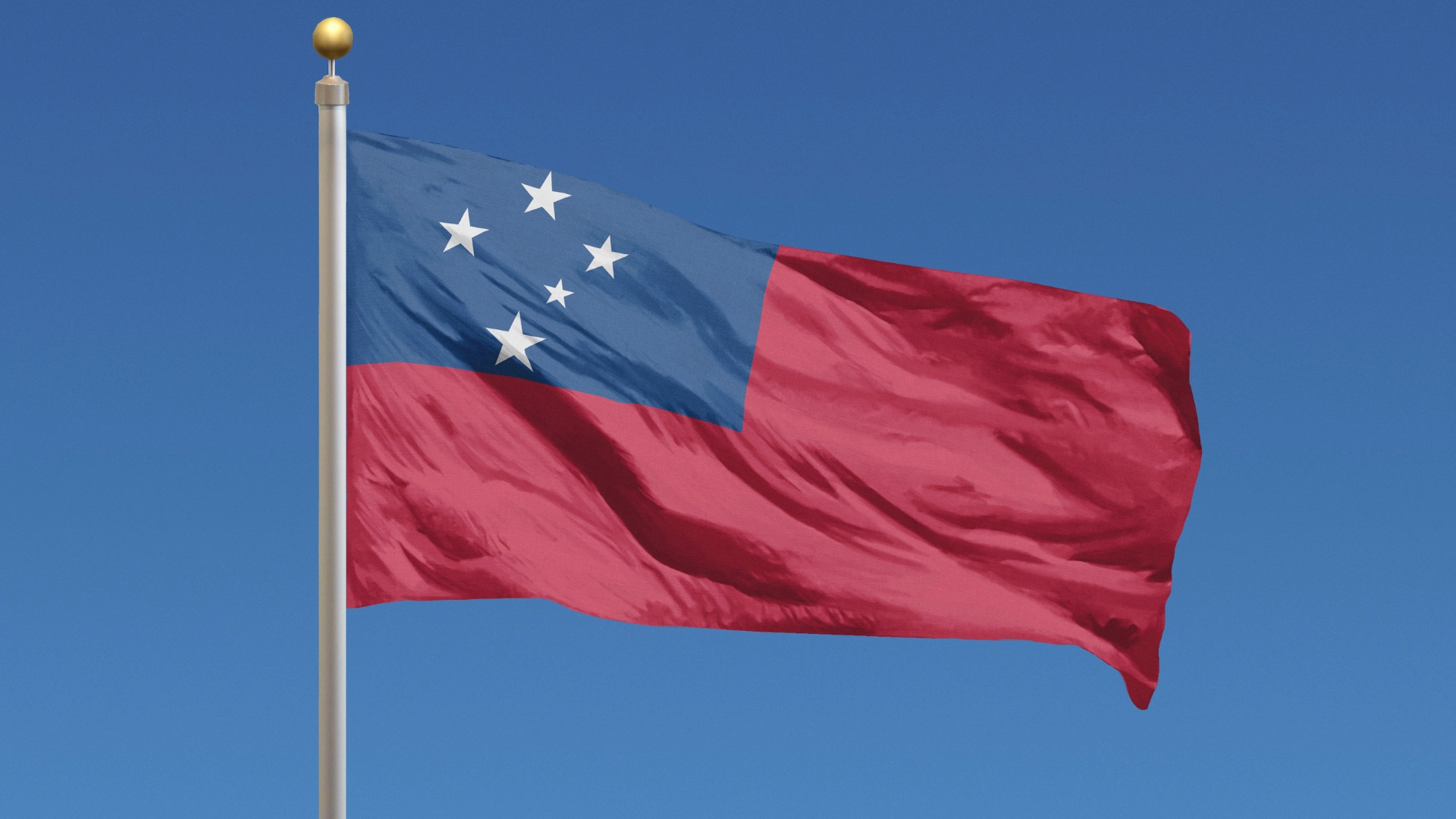 National flag of Samoa waving on a flagpole against a clear blue sky