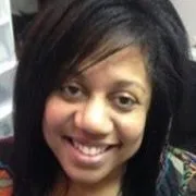 A smiling woman with dark hair and eyes looks directly at the camera