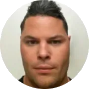 Head shot of a man with short brown hair and eyes with a serious expression