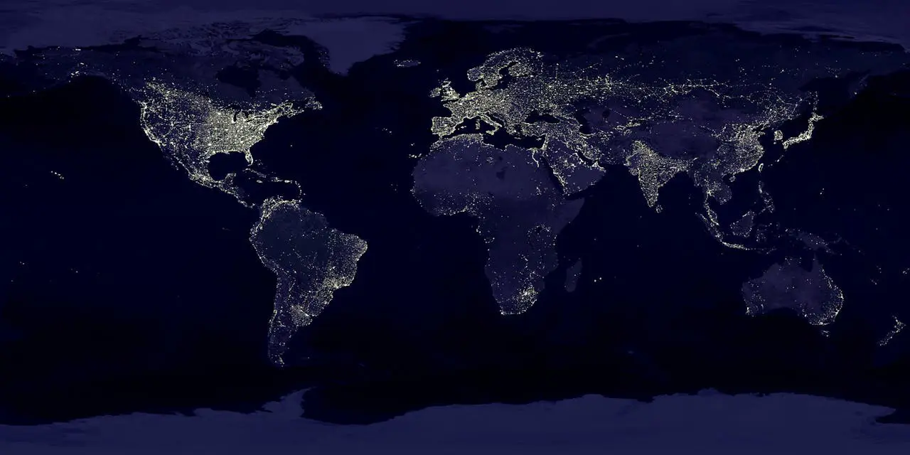 night time world map showing all major cities around the world lit up by the city lights.