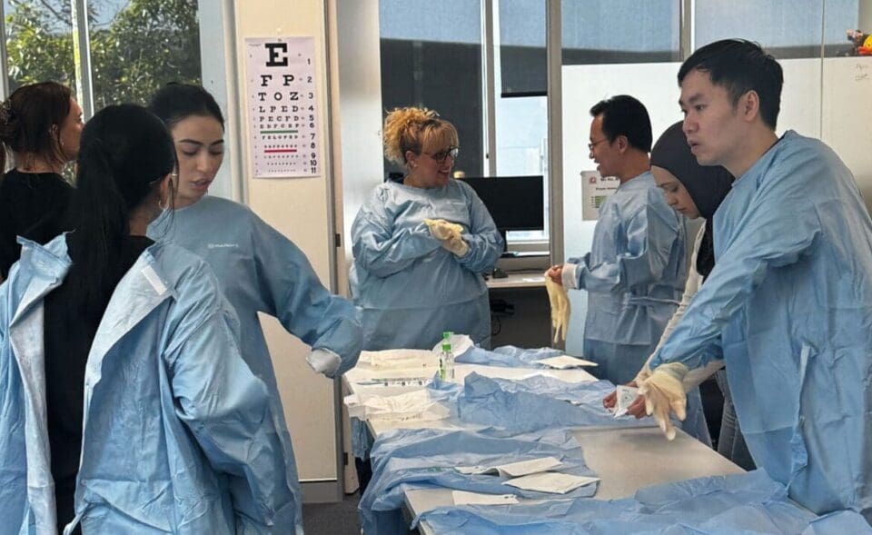 Med students learning about sterilized gowning during clinical training