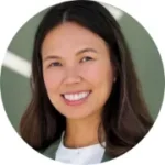 Headshot of smiling young Asian woman with long brown hair