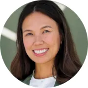 Headshot of smiling young Asian woman with long brown hair